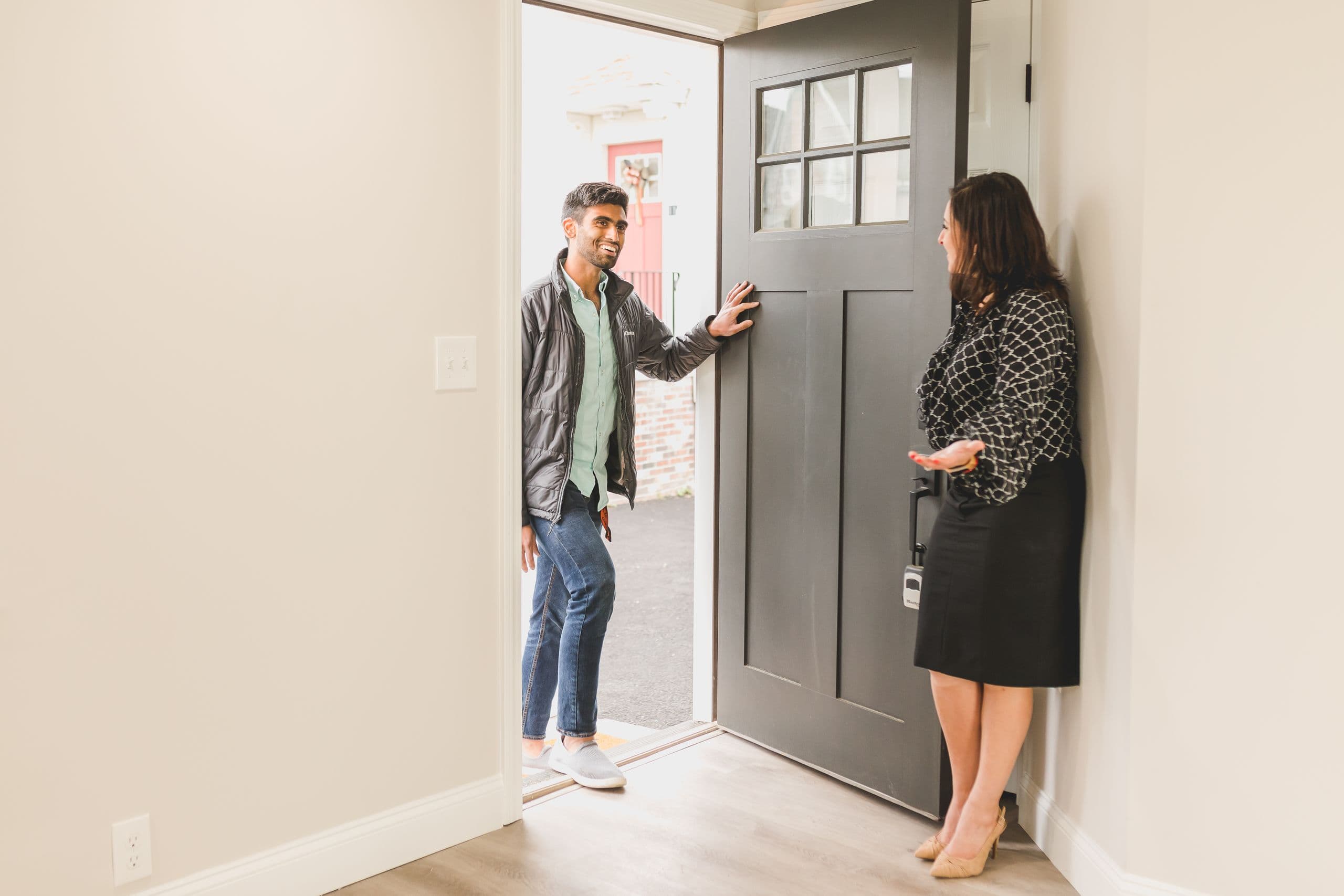 An agent welcoming clients to a Sunshine Coast property